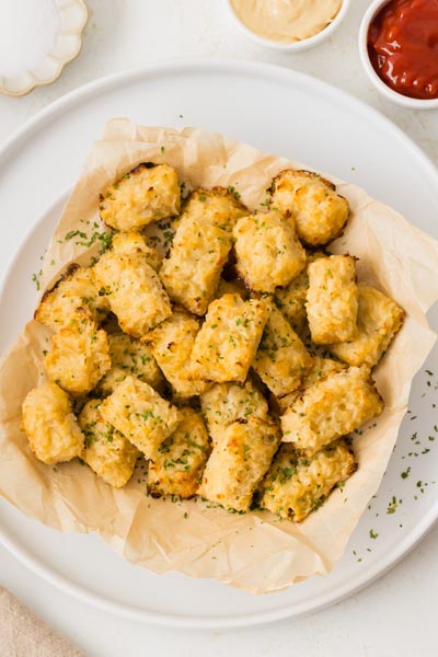 Seasoned cauliflower tots that are high protein on a plate.