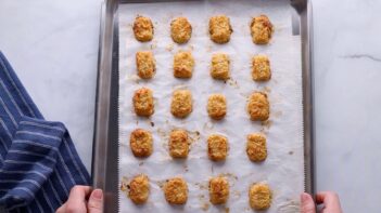 Baked cauliflower tots on a tray.