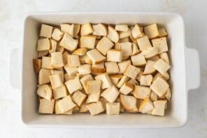 Toasted pieces of keto bread in a white casserole dish.