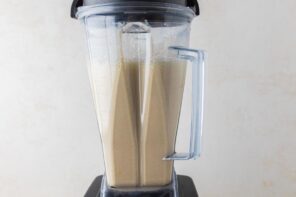 A blender with a frothy custard mixture inside.