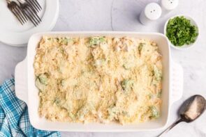 A chicken casserole topped with breadcrumbs in a white baking dish.