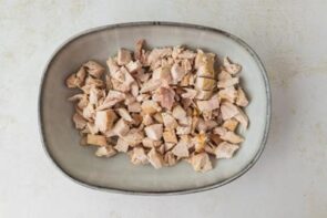 Diced cooked chicken in a bowl.