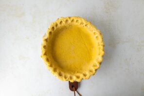 A blind baked pie crust with fluted edges.