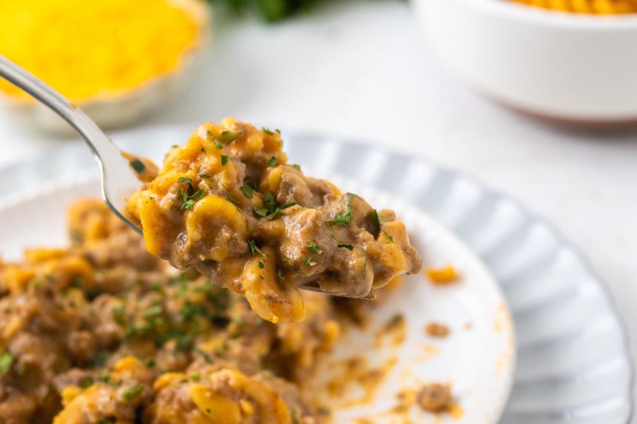 A bite of hamburger helper dinner on a fork.