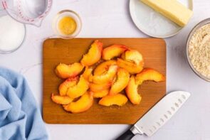 Sliced peaches on a cutting board.