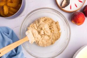 Cobbler dough in a mixing bowl with a spatula.