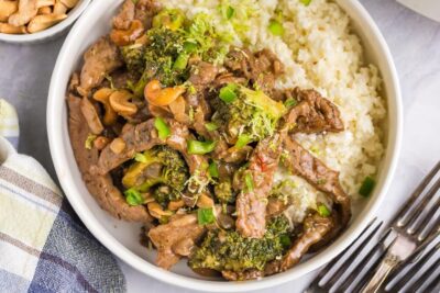 Juicy and saucy chinese cashew beef over coconut rice in a bowl.