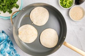 Frying smashed tacos in a non-stick skillet.