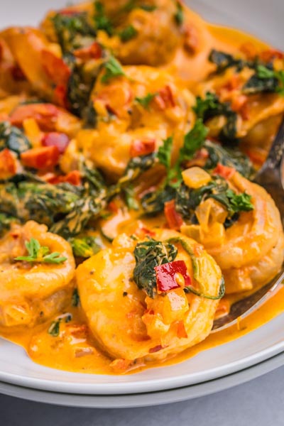 Cook shrimp in a creamy sauce with spinach and red pepper.