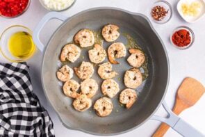 Cooked shrimp in a skillet.